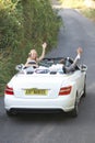 Bride And Groom Driving Away In Decorated Car Royalty Free Stock Photo