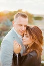 Bride and groom embrace with their eyes closed. Portrait