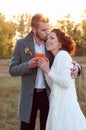 Bride and groom embracing. Romantic autumn outdoor setting. Royalty Free Stock Photo