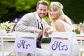 Bride And Groom Enjoying Meal At Wedding Reception Royalty Free Stock Photo