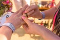 Bride and groom exchange rings during the wedding ceremony