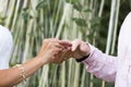 Bride and groom are exchanging wedding rings