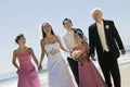 Bride and Groom with family on beach (portrait) Royalty Free Stock Photo