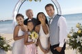 Bride and Groom with family on beach (portrait) Royalty Free Stock Photo