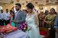Bride, groom, family, and friends attending the Catholic wedding ceremony. Religious celebration at church in Kerala province in