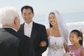 Bride and Groom with family by ocean Royalty Free Stock Photo