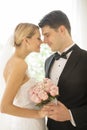 Bride And Groom With Flower Bouquet Rubbing Noses Royalty Free Stock Photo