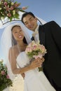 Bride And Groom With Flowers At Beach Royalty Free Stock Photo