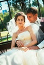 The bride and groom in the gazebo in the park