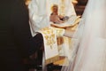 Bride and groom giving vows at wedding ceremony, hands closeup