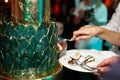 Bride and groom and green multilevel wedding cake Royalty Free Stock Photo