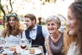 Bride and groom with guests at wedding reception outside in the backyard. Royalty Free Stock Photo
