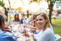 Bride and groom with guests at wedding reception outside in the backyard. Royalty Free Stock Photo