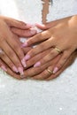 Bride and groom hands with fingers rings in wedding day on marriage dress background Royalty Free Stock Photo