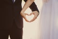 The bride and groom hands forming heart shape a symbol of love Royalty Free Stock Photo