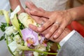 Bride groom hands of the newlyweds with wedding rings on bouquet Royalty Free Stock Photo