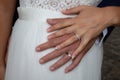 Bride and groom hands with rings in wedding day on marriage dress background Royalty Free Stock Photo