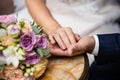 Bride and groom hands with wedding bouquet, concept of tenderness and love Royalty Free Stock Photo