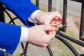 The bride and groom hang the wedding lock on the bridge. The keys and the padlock symbol of love and fidelity. Wedding tradition. Royalty Free Stock Photo