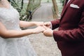 Bride and groom happy newly wedding couple hold hands together in the garden