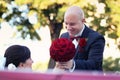 The bride and groom have fun behind the wheel of red retro vintage car. Wedding. Royalty Free Stock Photo