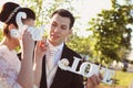 Bride and groom having fun and posing with Sweet Love letters in sunlight Royalty Free Stock Photo