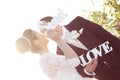 Bride and groom having fun and posing with Sweet Love letters in sunlight Royalty Free Stock Photo