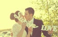 Bride and groom having fun and posing with Sweet Love letters in sunlight Royalty Free Stock Photo