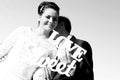 Bride and groom having fun and posing with Sweet Love letters in sunlight Royalty Free Stock Photo