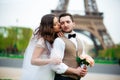 Bride and groom having a romantic moment on their wedding day in Paris, in front of the Eiffel tour Royalty Free Stock Photo