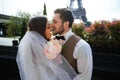 Bride and groom having a romantic moment on their wedding day in Paris, in front of the Eiffel tour Royalty Free Stock Photo