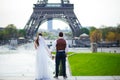 Bride and groom having a romantic moment on their wedding day in Paris, in front of the Eiffel tour Royalty Free Stock Photo