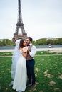 Bride and groom having a romantic moment on their wedding day in Paris, in front of the Eiffel tour Royalty Free Stock Photo