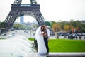 Bride and groom having a romantic moment on their wedding day in Paris, in front of the Eiffel tour Royalty Free Stock Photo