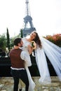 Bride and groom having a romantic moment on their wedding day in Paris, in front of the Eiffel tour Royalty Free Stock Photo