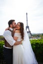 Bride and groom having a romantic moment on their wedding day in Paris, in front of the Eiffel tour Royalty Free Stock Photo