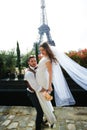 Bride and groom having a romantic moment on their wedding day in Paris, in front of the Eiffel tour Royalty Free Stock Photo