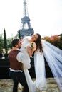 Bride and groom having a romantic moment on their wedding day in Paris, in front of the Eiffel tour Royalty Free Stock Photo