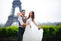 Bride and groom having a romantic moment on their wedding day in Paris, in front of the Eiffel tour Royalty Free Stock Photo