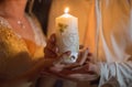 The bride and groom hold a big candle in hands Royalty Free Stock Photo