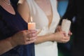 Bride and groom hold a candle in their hands. Royalty Free Stock Photo