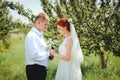 Bride and groom hold each other hands while they walk along the Royalty Free Stock Photo