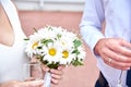 Bride and groom hold glasses of champagne and a bouquet on their wedding day Royalty Free Stock Photo