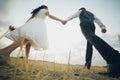 Bride and groom hold hands and meet the sunset. Wedding Royalty Free Stock Photo