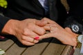 Bride and groom hold hands, sunny day,  rings close-up, black and white costume, yin and yang,bouquet dark red burgundy peony Royalty Free Stock Photo