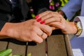 bride and groom hold hands, sunny day, rings close-up, black and white costume, yin and yang,bouquet dark red burgundy peony Royalty Free Stock Photo