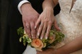 The bride and groom hold hands Under the arms a wedding bouquet of flowers