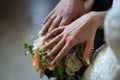 The bride and groom hold hands Under the arms a wedding bouquet of flowers
