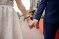 A bride and groom hold hands Royalty Free Stock Photo