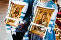 The bride and groom hold in hands wedding icons after the wedding ceremony and leave the church. Happy lovers on a wedding day.